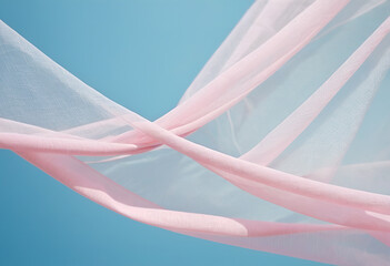 Flying pink transparent fabric wave on blue background and illuminated by sunlight