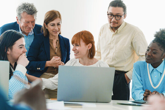 Multicultural colleagues discussing project - Positive feedback in team meeting - Inclusive workplace dynamic.