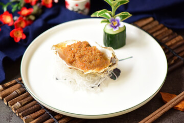 Garlic charcoal grilled oysters placed on a plate