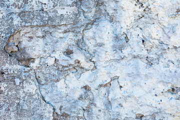 Glacier textures old plastered concrete wall with cracked and fallen paint, for background