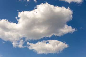 Big cumulus fluffy cloud, in blue sky aerial view