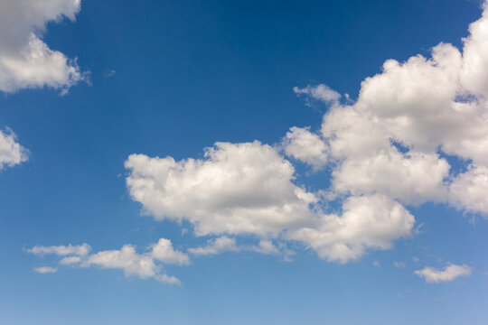 Beautiful background image of a romantic blue sky with soft fluffy white clouds