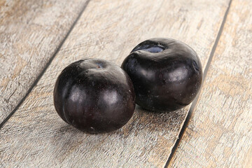 Two ripe sweet black plums
