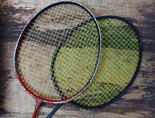 Top view of two rackets on the wooden board. 