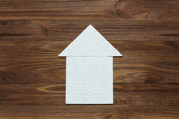 Obraz na płótnie Canvas Home Puzzle on Wooden Surface