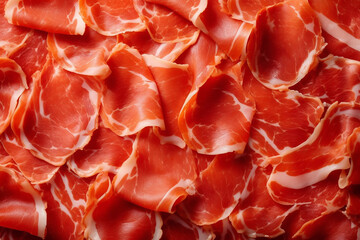 Thinly sliced cured ham with marbled texture and vibrant pink and white colors.
