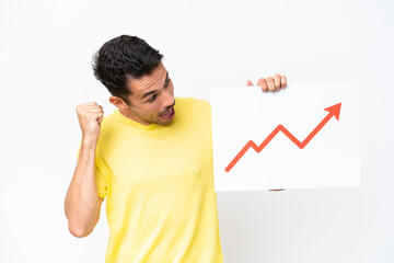 Young handsome man over isolated white background holding a sign with a growing statistics arrow...