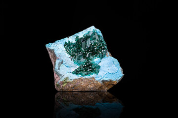 green dioptase on blue plancheite photography isolated on black blackground. From Sanda, Mindouli District, Pool Department, Republic of the Congo
