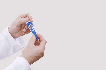 Doctor checking a digital thermometer