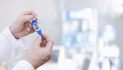 Doctor checking a digital thermometer