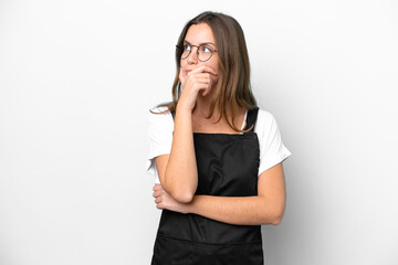 Young caucasian restaurant waiter woman isolated on white background having doubts and with confuse face expression