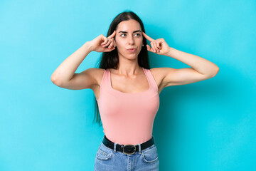 Young caucasian woman isolated on blue background having doubts and thinking