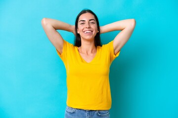 Young caucasian woman isolated on blue background laughing