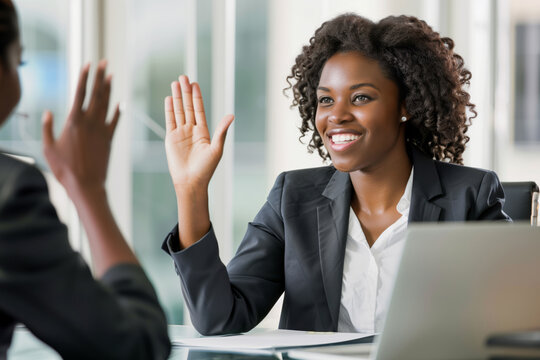 African American Woman Smiling and Giving High-Five to Colleague in Office