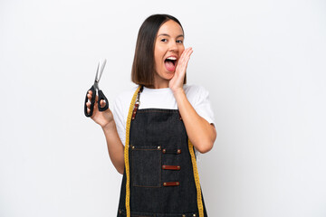 Young seamstress woman isolated on white background with surprise and shocked facial expression
