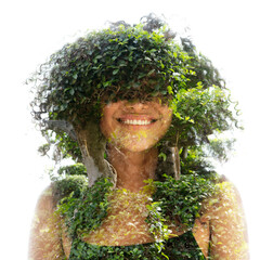 A full-front double exposure portrait of a young woman smiling with frizzy hair - 745092250