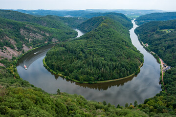 Majestic view of Saar River flowing through the famous Saarschleife in western Germany, surrounded...