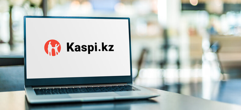 Laptop computer displaying logo of Kaspi.kz