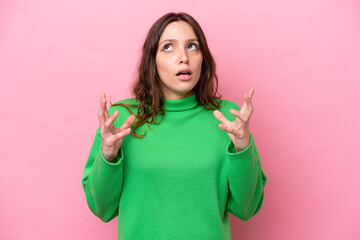 Young caucasian woman isolated on pink background stressed overwhelmed