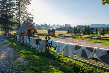 Traditional wooden shepherd's hut in Poland's Tatra Mountains with various rugs and sheepskins hung...