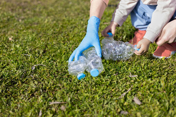 Single-parent family clearing the countryside of plastic waste