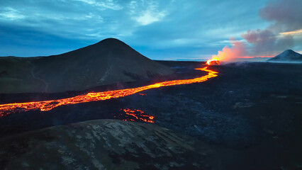 Aerial view over volcanic eruption, Night view, Mount Fagradalsfjall lava spill out of the crater Mount Fagradalsfjall, July 2023, Iceland. Impressive aerial View of the active volcano explosions