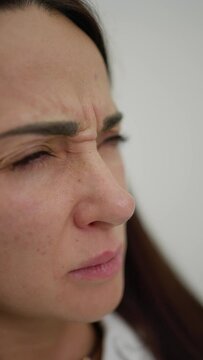 Woman Examining Facial Wrinkles. Close-up of woman's face showing concern over forehead wrinkles.