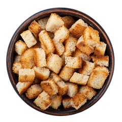 Bread rusks. Fried pieces of bread in a clay bowl isolated on white background. Caesar salad ingredients. Delicious snacks. Top view.