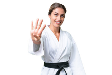 Young Uruguayan woman doing karate over isolated background happy and counting four with fingers