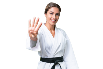 Young Uruguayan woman doing karate over isolated background happy and counting four with fingers