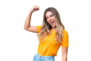 Young Uruguayan woman over isolated background celebrating a victory - obrazy, fototapety, plakaty