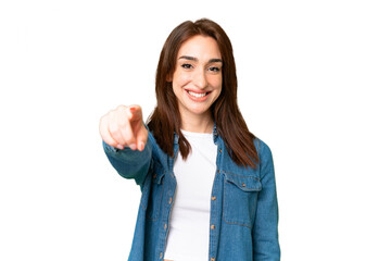 Young caucasian woman over isolated chroma key background pointing front with happy expression