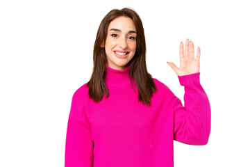 Young caucasian woman over isolated chroma key background saluting with hand with happy expression