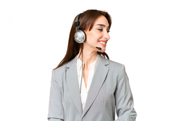 Telemarketer caucasian woman working with a headset over isolated chroma key background looking side