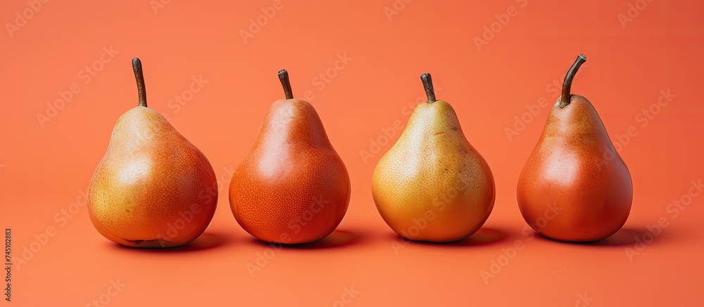 Poster five ripe pears are neatly lined up in a row against a vibrant orange background in a high-resolutio
