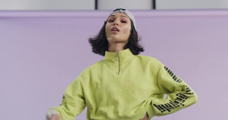 Face mask, style and cool woman with fashion in studio, purple background or mockup space. Streetwear, aesthetic and portrait of person with confidence, pride and model remove covid 19 protection