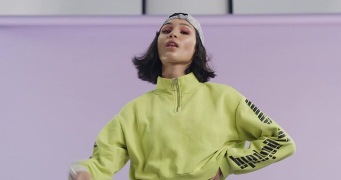 Face mask, style and cool woman with fashion in studio, purple background or mockup space. Streetwear, aesthetic and portrait of person with confidence, pride and model remove covid 19 protection