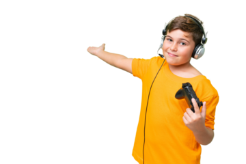 Little caucasian kid playing with a video game controller over isolated chroma key background extending hands to the side for inviting to come