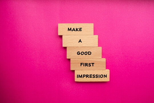 Make a good first impression words written on wooden blocks with pink background. Conceptual symbol. Copy space.