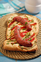 Savory pastry with sausages and vegetables. Coca de recapte, typical from Catalonia, Spain.