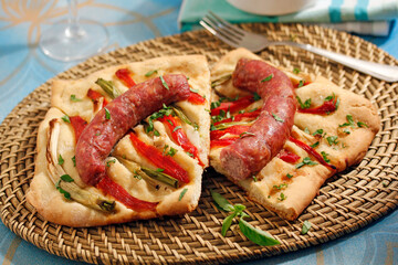 Savory pastry with sausages and vegetables. Coca de recapte, typical from Catalonia, Spain.