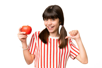Little caucasian girl holding an apple over isolated background proud and self-satisfied
