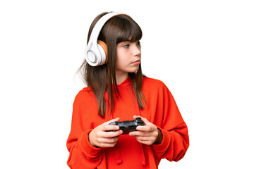 Little caucasian girl playing with a video game controller over isolated background looking to the side