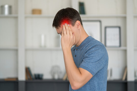 Headache and migraine, man with head pain at home