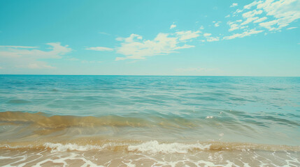 Serene Beachside Horizon under Clear Blue Skies, Calm turquoise sea meets a clear sky, gentle waves lapping sandy shore