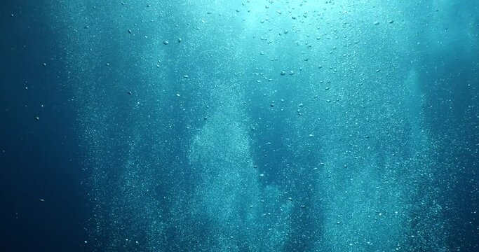 air bubbles slow  underwater coming up scenery dark blue and sun shine ocean scenery from scuba  divers backgrounds