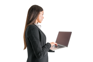 Focused businesswoman typing on laptop, standing on white background, professional work concept
