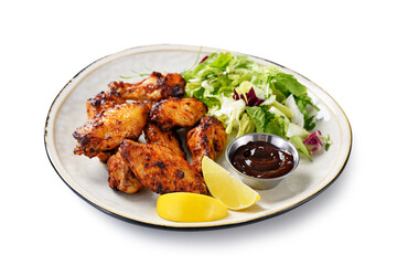 Air fryer chicken wings with fresh green salad, barbecue sauce and lemon slices. isolated on white background