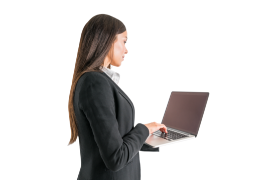 Focused businesswoman typing on laptop, standing on white background, professional work concept - Powered by Adobe