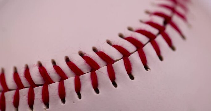 white baseball ball tied with red thread, a real round baseball ball close-up
